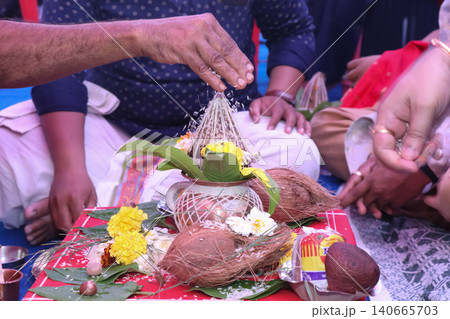 Performing Kalash puja rituals in Indian traditional wedding ceremony Performing Kalash puja rituals in Indian traditional wedding ceremony 140665703