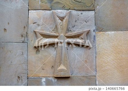 This carved stone relief is consistent with a Maltese cross. This carved stone relief is consistent with a Maltese cross. 140665766