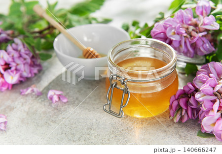 Organic honey jar with fresh blooming acacia flowers Organic honey jar with fresh blooming acacia flowers 140666247