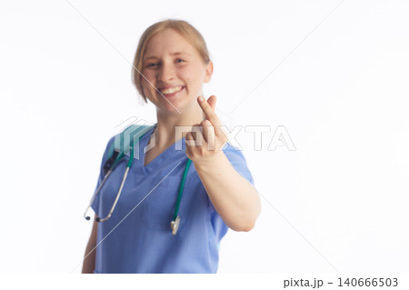 Friendly Nurse Making a Finger Heart Gesture 140666503