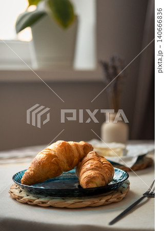 Morning breakfast with croissants on table by window 140666836