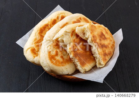 traditional Chinese Guokuei Flatbread Served on a Wooden Plate. Crispy Baked Shanjian Pancake, Asian Street Food Snack. traditional Chinese Guokuei Flatbread Served on a Wooden Plate. Crispy Baked Shanjian Pancake, Asian Street Food Snack. 140668279