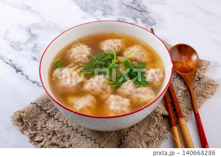 chinese Wonton Soup with Sweet Corn and Pork Stuffing. Hot Asian Dumpling Soup with Cilantro, Comfort Noodle Alternative. chinese Wonton Soup with Sweet Corn and Pork Stuffing. Hot Asian Dumpling Soup with Cilantro, Comfort Noodle Alternative. 140668286