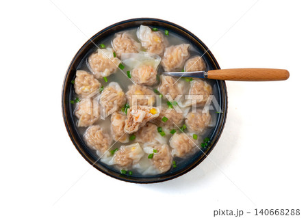 bowl of traditional Chinese pork and shrimp wontons in clear broth with chopped scallions, classic dim sum soup 140668288