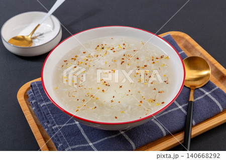 traditional Chinese sweet rice wine soup with a poached egg and osmanthus flowers, sweet fermented rice dessert traditional Chinese sweet rice wine soup with a poached egg and osmanthus flowers, sweet fermented rice dessert 140668292