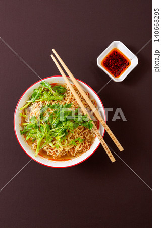 bowl of Instant Noodles Generously Topped with Fresh Coriander. Asian Style Spicy Ramen Soup, Quick Comfort Food. bowl of Instant Noodles Generously Topped with Fresh Coriander. Asian Style Spicy Ramen Soup, Quick Comfort Food. 140668295
