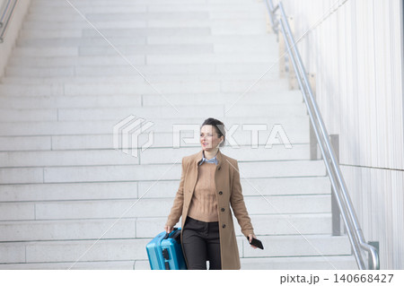 Traveling Woman Smiling on Train Station Stairs Traveling Woman Smiling on Train Station Stairs 140668427