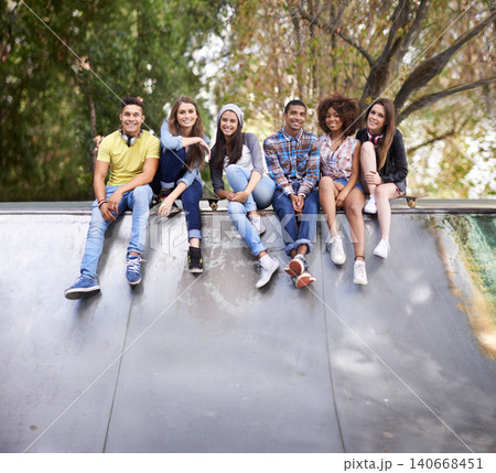 Serious, portrait and group of friends at skatepark for bonding, skating and sitting together. Gen z, diversity and young people with skateboard for practice or training for competition together. 140668451