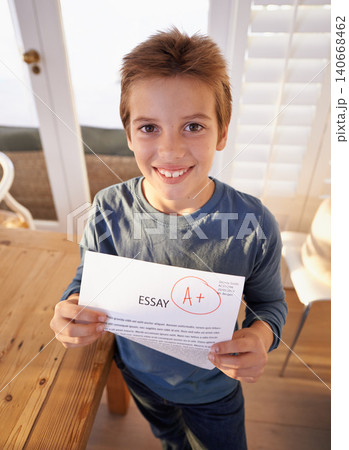Child, portrait and paper exam for school learning or student essay in home or scholarship, goals or academic. Male person, face and document pride for education mark or study, results or success 140668462
