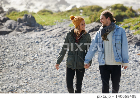 Walking, holding hands and beach with couple, nature and happiness with vacation and romance. Seaside, relationship and man with woman or marriage with holiday for honeymoon and adventure with smile Walking, holding hands and beach with couple, nature and happiness with vacation and romance. Seaside, relationship and man with woman or marriage with holiday for honeymoon and adventure with smile 140668489