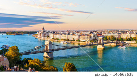 Budapest panorama view of Hungarian Parliament Building and Chain Bridge over Danube River at sunset, Hungary Budapest panorama view of Hungarian Parliament Building and Chain Bridge over Danube River at sunset, Hungary 140668639