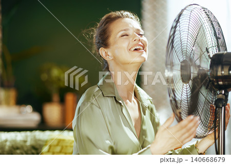 Happy Woman Embracing Fan\'s Breeze in Summer 140668679