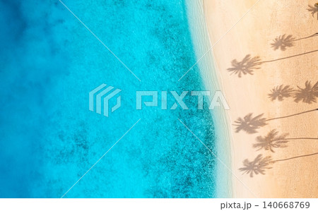 Aerial turquoise lagoon panoramic palm shadows. Powdery white sand meets crystal shallows from above. Wide drone vista tropical paradise, peaceful summer travel banner Aerial turquoise lagoon panoramic palm shadows. Powdery white sand meets crystal shallows from above. Wide drone vista tropical paradise, peaceful summer travel banner 140668769