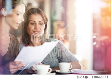 People, reading and meeting at cafe with paperwork, proposal or women problem solving together. Business, collaboration and conversation in coffee shop with feedback on review or advice for report People, reading and meeting at cafe with paperwork, proposal or women problem solving together. Business, collaboration and conversation in coffee shop with feedback on review or advice for report 140668841