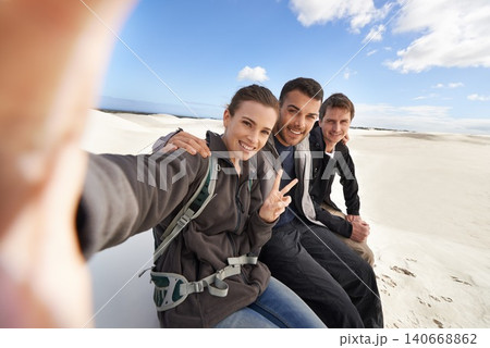 Friends, desert and selfie with smile for adventure in happiness for holiday, road trip and travel together. People, memory and excited in sand dunes for vacation or break with bonding for fun Friends, desert and selfie with smile for adventure in happiness for holiday, road trip and travel together. People, memory and excited in sand dunes for vacation or break with bonding for fun 140668862