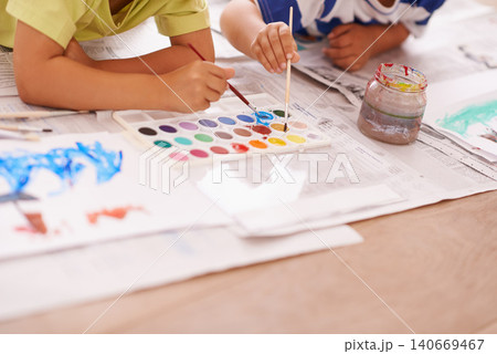 Children hands, palette and creative with paint brush on floor or playing, hobby and drawing together at home. Kids, motor skills and growth for childhood development with creativity for artwork Children hands, palette and creative with paint brush on floor or playing, hobby and drawing together at home. Kids, motor skills and growth for childhood development with creativity for artwork 140669467