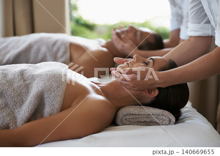 Hands, face massage and couple in spa to relax on bed for luxury pamper treatment together in hotel. Beauty, facial or zen woman with man at resort or salon for natural healing benefits or skincare 140669655