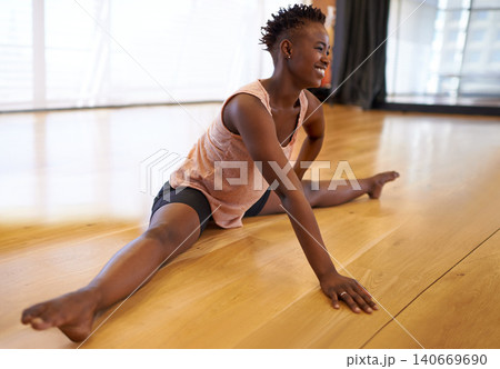 Dancer, stretching and person on floor in studio or academy preparing for practice and start rehearsal in exercise. Training, fitness and healthy workout for legs with yoga, pilates and happiness Dancer, stretching and person on floor in studio or academy preparing for practice and start rehearsal in exercise. Training, fitness and healthy workout for legs with yoga, pilates and happiness 140669690