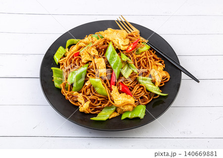 stir-Fried Noodles with Eggs and Green Peppers, Chinese Chow Mein on Black Plate stir-Fried Noodles with Eggs and Green Peppers, Chinese Chow Mein on Black Plate 140669881