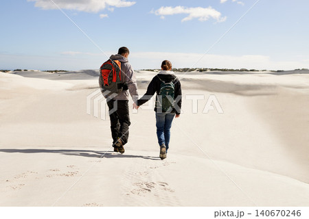 Backpack, travel or couple in desert holding hands for adventure, journey or resort, location or explore. Freedom, love or back of people in Egypt for sand dunes walking, wellness or hiking in nature Backpack, travel or couple in desert holding hands for adventure, journey or resort, location or explore. Freedom, love or back of people in Egypt for sand dunes walking, wellness or hiking in nature 140670246