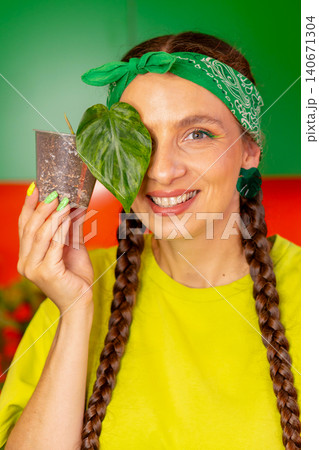 Woman Covering Eye With Heart Shaped Plant Leaf Woman Covering Eye With Heart Shaped Plant Leaf 140671304