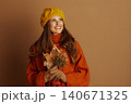 Joyful Young Woman Gazing Upwards with Fall Leaves Joyful Young Woman Gazing Upwards with Fall Leaves 140671325
