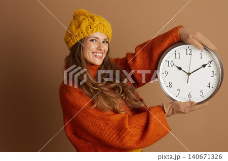 Presenting Time: Cheerful Woman in Fall Fashion 140671326