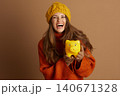 Cheerful Woman Celebrating Financial Savings Cheerful Woman Celebrating Financial Savings 140671328