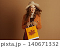 Cheerful Woman with Fedora and Autumn Shopping Cheerful Woman with Fedora and Autumn Shopping 140671332