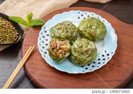 steamed sticky whole grain buns with sweet red bean filling on a blue ceramic plate steamed sticky whole grain buns with sweet red bean filling on a blue ceramic plate 140671660