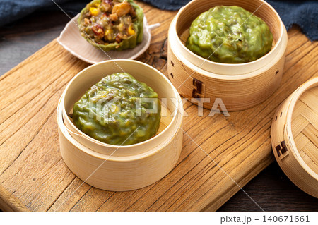 traditional Chinese steamed sticky grain buns (Nian Dou Bao) in a bamboo steamer traditional Chinese steamed sticky grain buns (Nian Dou Bao) in a bamboo steamer 140671661