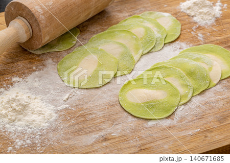 green Vegetable Dumpling Wrappers on Wooden Board, Homemade Chinese Dough green Vegetable Dumpling Wrappers on Wooden Board, Homemade Chinese Dough 140671685