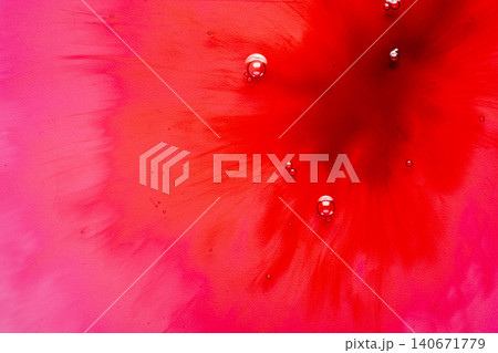 Macro view of red and pink liquid ink diffusing with small bubbles Macro view of red and pink liquid ink diffusing with small bubbles 140671779