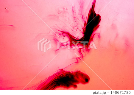 Abstract macro photography of red and black ink diffusing in liquid, creating beautiful organic swirls, smoky shapes and a fluid textured background Abstract macro photography of red and black ink diffusing in liquid, creating beautiful organic swirls, smoky shapes and a fluid textured background 140671780