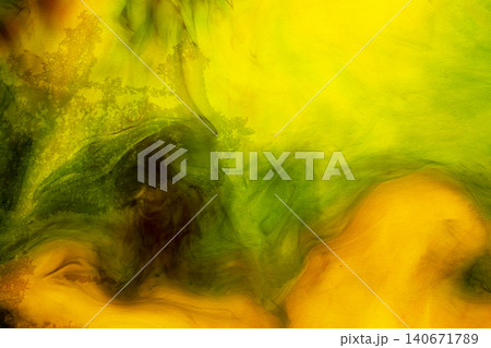 Abstract background of yellow and green ink swirling in water, creating vibrant fluid patterns and smoke-like textures Abstract background of yellow and green ink swirling in water, creating vibrant fluid patterns and smoke-like textures 140671789