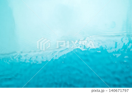 Clear turquoise blue water surface with gentle ripples and sunlight reflections. Perfect abstract background for summer or wellness themes Clear turquoise blue water surface with gentle ripples and sunlight reflections. Perfect abstract background for summer or wellness themes 140671797