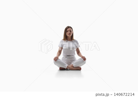 Calm young woman meditating in lotus pose on white background. Calm young woman meditating in lotus pose on white background. 140672214