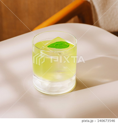 Refreshing green cocktail with ice and basil leaf Refreshing green cocktail with ice and basil leaf 140673546