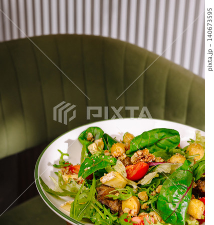 Fresh green salad with cheese and nuts Fresh green salad with cheese and nuts 140673595