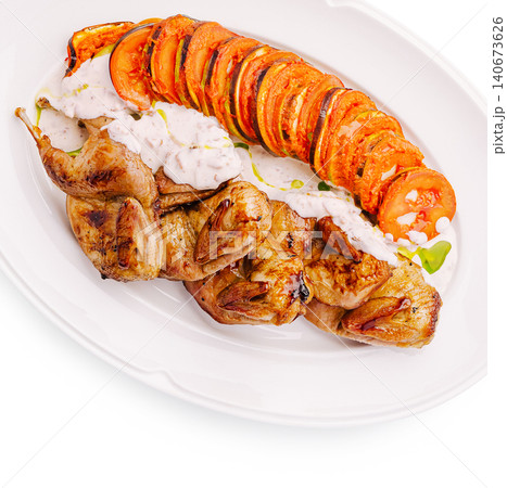 Grilled quail with ratatouille tian and yogurt sauce Grilled quail with ratatouille tian and yogurt sauce 140673626