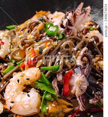 Asian soba noodle stir-fry with seafood closeup Asian soba noodle stir-fry with seafood closeup 140673654