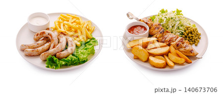 Two plates offering grilled sausage and chicken shish kebab meals Two plates offering grilled sausage and chicken shish kebab meals 140673706
