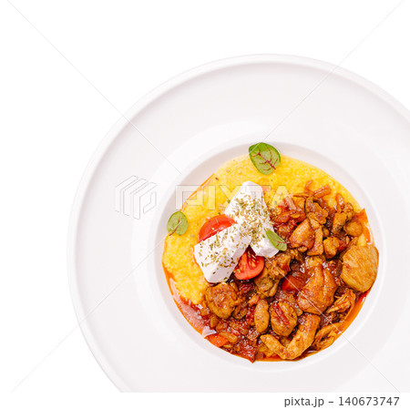 Chicken stew polenta with feta cheese and tomatoes Chicken stew polenta with feta cheese and tomatoes 140673747