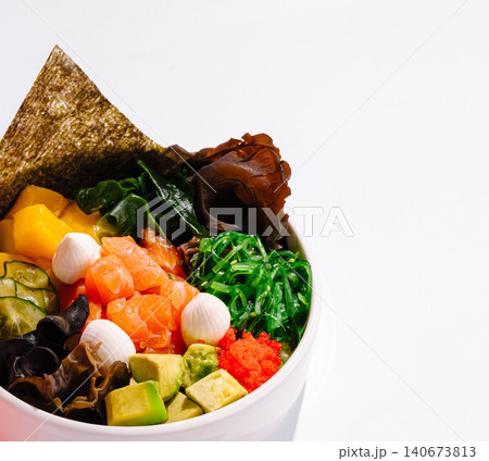 Fresh poke bowl with salmon, avocado, seaweed, and mango Fresh poke bowl with salmon, avocado, seaweed, and mango 140673813