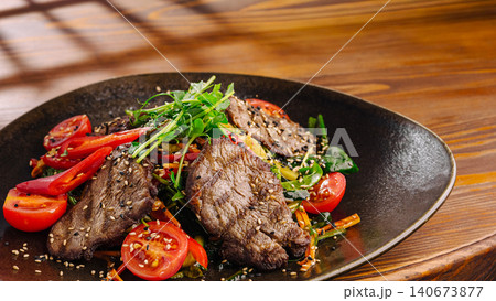 Grilled beef steak salad with fresh vegetables and sesame seeds Grilled beef steak salad with fresh vegetables and sesame seeds 140673877
