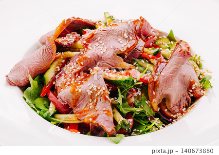 Roast beef salad with fresh arugula and sesame seeds Roast beef salad with fresh arugula and sesame seeds 140673880