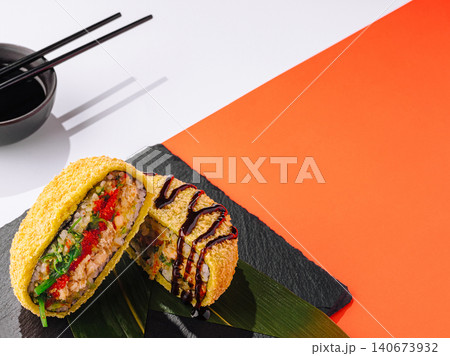 Crispy fried sushi burger with soy sauce and chopsticks Crispy fried sushi burger with soy sauce and chopsticks 140673932