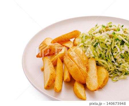 Potato wedges and coleslaw salad serving on plate Potato wedges and coleslaw salad serving on plate 140673948