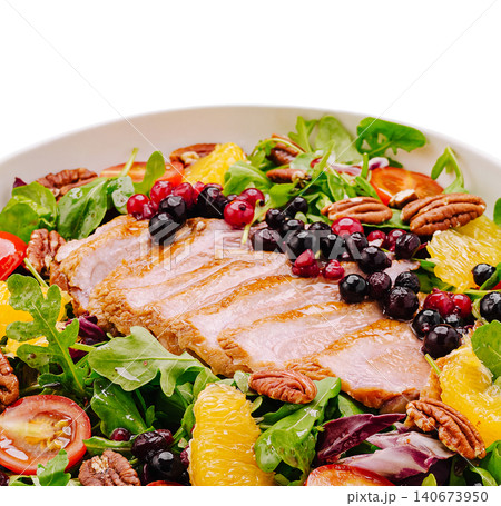 Duck breast salad with arugula, berries, oranges, pecans 140673950