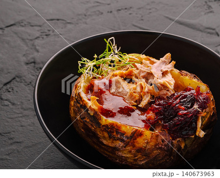 Baked potato with pulled pork, barbecue sauce, sprouts Baked potato with pulled pork, barbecue sauce, sprouts 140673963